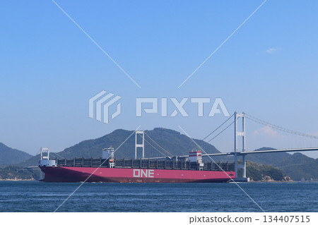A huge container ship sailing through the Kurushima Strait 134407515