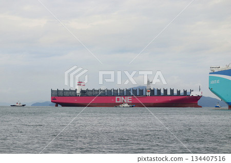 A huge container ship arrives at port 134407516