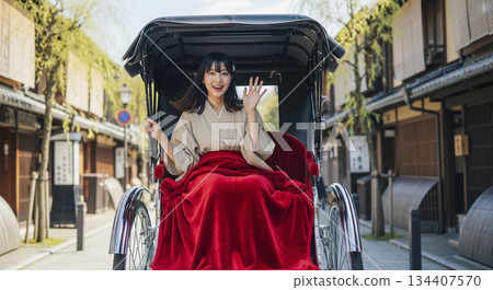 Woman riding a rickshaw 134407570