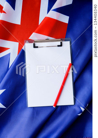 White empty paper copy space template mock up Australian flag background. National symbol and patriotism concept, ideal mock-up for custom copy designs. Place your logo or text on the white paper 134408340