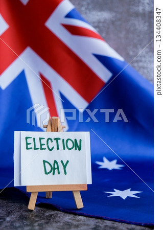 Australian flag with message text ELECTION DAY for political coverage. Patriotic signage and flag for voter outreach or campaign branding. Concept of democracy and civic duty suitable for voter Australian flag with message text ELECTION DAY for political coverage. Patriotic signage and flag for voter outreach or campaign branding. Concept of democracy and civic duty suitable for voter 134408347