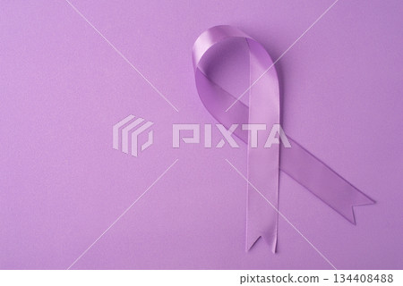 Lilac ribbon on purple background. World Cancer Day on February 4. 134408488