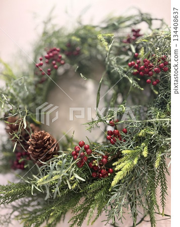 A natural Christmas wreath decorated on a white wall 134408637