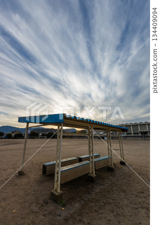Cirrus clouds and a covered bench on the ground Cirrus clouds and a covered bench on the ground 134409094