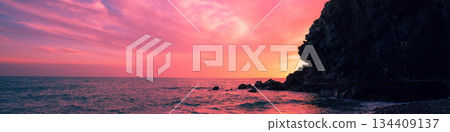 Sunset over rocky sea coast Sunset over rocky sea coast 134409137