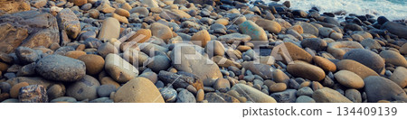 Deserted rocky pebble beach. Abstract nature pebbles background. Pebbles texture. Stone beach. Horizontal banner Deserted rocky pebble beach. Abstract nature pebbles background. Pebbles texture. Stone beach. Horizontal banner 134409139