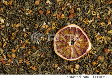 high-quality green tea with added flavors and pieces of fruit and cut dried red oranges, bright large dry slices of blood red orange and green tea with pieces of fruit 134409529