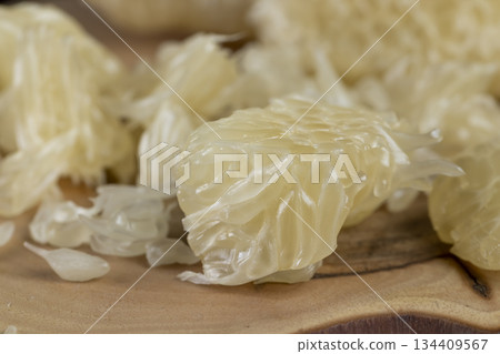 peeled ripe and juicy grapefruit pulp broken into pieces, pieces and slices of ripe grapefruit on the table 134409567