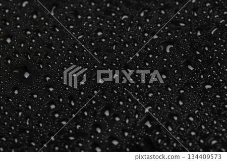 shiny surface covered with clear water droplets of different sizes, black glass covered with a large number of water droplets 134409573