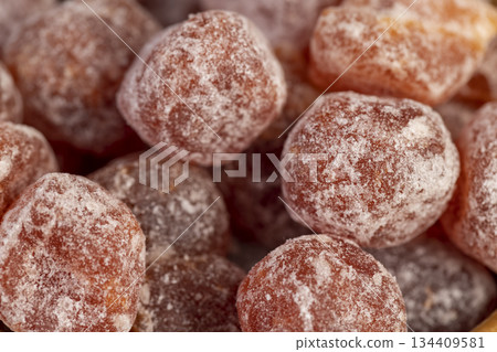 dry fruits of fragrant kumquat dried in sugar syrup, food details, round dehydrated kumquat fruit in a wooden bowl 134409581