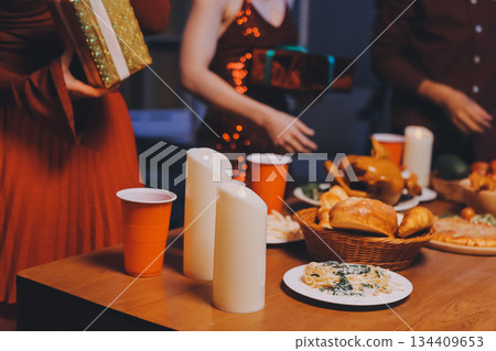 Festive Office Christmas Party with Delicious Food. A beautifully decorated office space with Christmas trees and festive lights, set up for a holiday party. 134409653