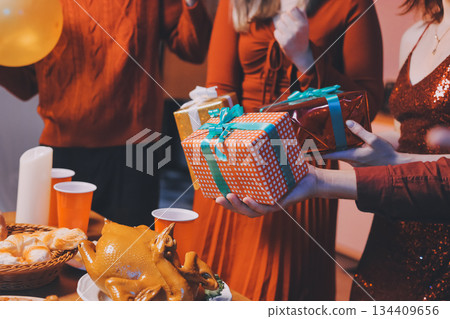Festive Office Christmas Party with Delicious Food. A beautifully decorated office space with Christmas trees and festive lights, set up for a holiday party. 134409656