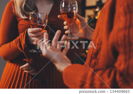 Festive Office Christmas Party with Delicious Food. A beautifully decorated office space with Christmas trees and festive lights, set up for a holiday party. 134409665