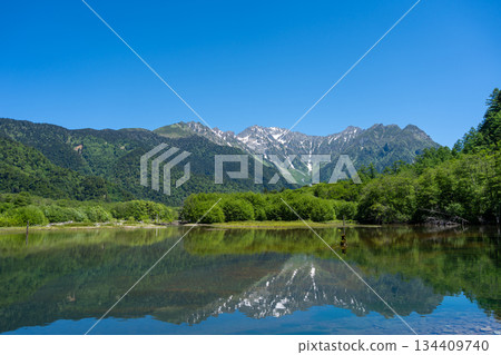 Mount Hotaka reflection on Kamikochi hiking trail in Japan 134409740