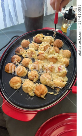 Cooking takoyaki in an electric griddle 134410083