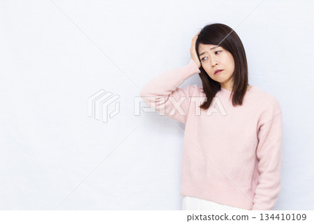A woman suffering from a headache A woman suffering from a headache 134410109