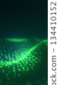 Flowing wave of glowing green digital particles on a dark background 134410152