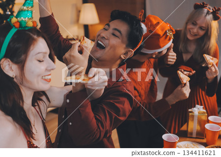 Festive Office Christmas Party with Delicious Food. A beautifully decorated office space with Christmas trees and festive lights, set up for a holiday party. 134411621