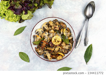 Delicious cooked mushrooms on table. Delicious cooked mushrooms on table. 134411772