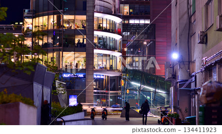 Warsaw, Poland. 4 November 2025. City life after dark. Dense corporate development in center city in the night. Lights street and buildings towering around them. Warsaw, Poland. 4 November 2025. City life after dark. Dense corporate development in center city in the night. Lights street and buildings towering around them. 134411923