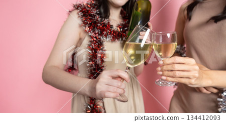 Cheers Close up of two friends toasting with champagne glasses at a festive gathering. 134412093