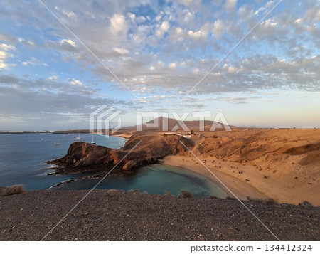 Papagayo Beach, Lanzarote: A stunning beach with golden sand, turquoise waters, and secluded coves. Cloudy sky. Evening time. Lanzarote island 134412324