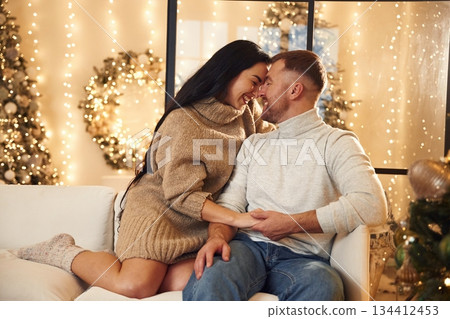 Couple is celebrating new year indoors together Couple is celebrating new year indoors together 134412453