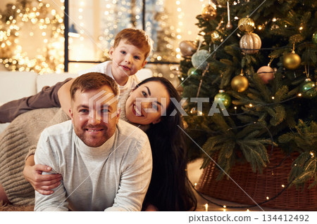 Well decorated tree. Happy family celebrating new year together at home 134412492