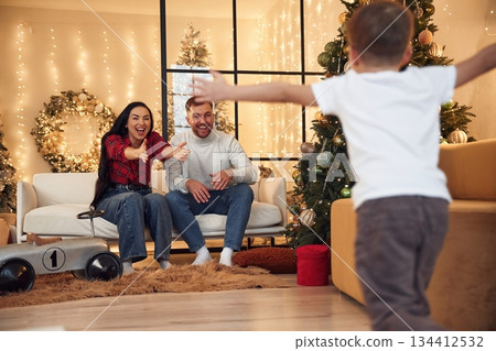 Having fun. Happy family celebrating new year together at home Having fun. Happy family celebrating new year together at home 134412532