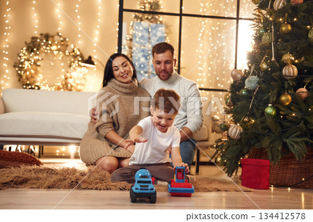 Happy family celebrating new year together at home Happy family celebrating new year together at home 134412578