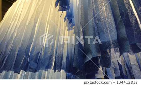 Abstract blue fabric texture with soft light folds 134412812