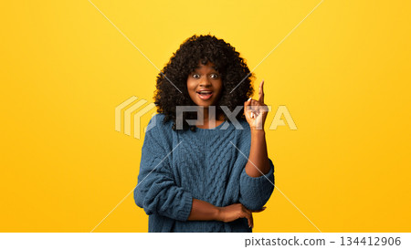 Cute young black woman in green outfit pointing finger up on yellow studio background, having great idea, copy space. Inspired african american lady with curly hair found solution Cute young black woman in green outfit pointing finger up on yellow studio background, having great idea, copy space. Inspired african american lady with curly hair found solution 134412906