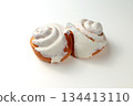 Fragrant Cinnabons with cream on a white background. Insulation 134413110
