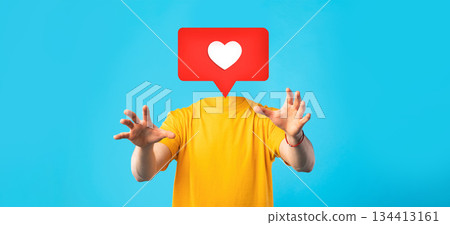 A person in a yellow shirt reaches out with their hands, while a large heart icon floats above where their head should be. 134413161