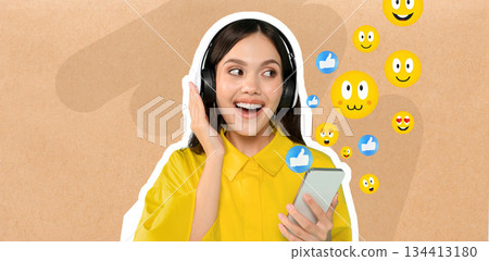 A woman with long hair is smiling and engaging in a chat on her smartphone while wearing headphones. She is surrounded by cheerful emoji icons, highlighting her enjoyment of social media. A woman with long hair is smiling and engaging in a chat on her smartphone while wearing headphones. She is surrounded by cheerful emoji icons, highlighting her enjoyment of social media. 134413180