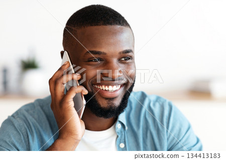 Pleasant Call. Positive Millennial Black Man Talking On Mobile Phone And Smiling, Cheerful African American Guy Enjoying Phone Conversation, Looking Aside With Pleased Face Expression, Closeup Pleasant Call. Positive Millennial Black Man Talking On Mobile Phone And Smiling, Cheerful African American Guy Enjoying Phone Conversation, Looking Aside With Pleased Face Expression, Closeup 134413183