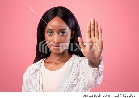 Thank you but no concept. Serious black woman making stop gesture on pink studio background. Assertive African American woman showing denial sign, expressing her rejection, refusing something Thank you but no concept. Serious black woman making stop gesture on pink studio background. Assertive African American woman showing denial sign, expressing her rejection, refusing something 134413265