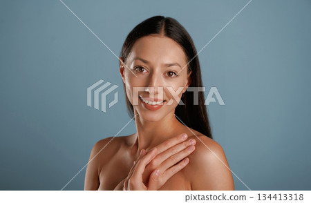 Clean skin. Young woman is in the studio against background 134413318