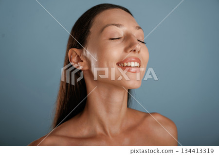 Clean skin. Young woman is in the studio against background 134413319