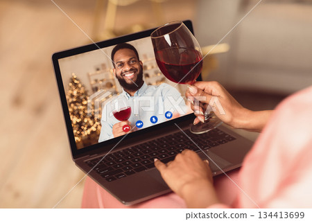 Online Date, Safe Meeting With Friends. Over The Shoulder View Of African American Woman Talking By Video Chat To Her Boyfriend Using Laptop And Drinking Red Wine. Stay Home. Social Distance. Online Date, Safe Meeting With Friends. Over The Shoulder View Of African American Woman Talking By Video Chat To Her Boyfriend Using Laptop And Drinking Red Wine. Stay Home. Social Distance. 134413699