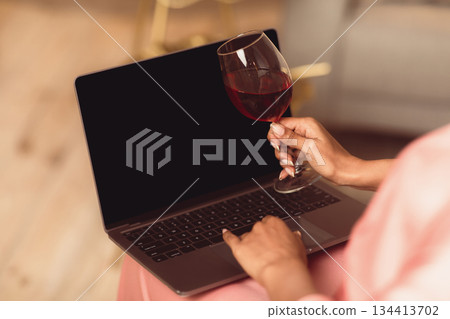 Online Party, Safe Meeting With Friends. Over The Shoulder Back View Of African American Woman Using Laptop With Blank Mockup Screen Talking By Video Chat, Holding Glass With Red Wine 134413702