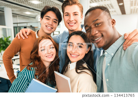 Cheerful Multicultural Students Posing Together Making Selfie In University Lecture Hall Indoors, Having Fun And Looking At Camera, Point Of View. College Friends, High School Education Concept Cheerful Multicultural Students Posing Together Making Selfie In University Lecture Hall Indoors, Having Fun And Looking At Camera, Point Of View. College Friends, High School Education Concept 134413765