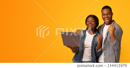 Online Win. Excited African American Couple Celebrating Success With Laptop Computer, Emotional Black Man And Woman Raising Fists And Shouting With Joy, Isolated Over Yellow Background, Copy Space Online Win. Excited African American Couple Celebrating Success With Laptop Computer, Emotional Black Man And Woman Raising Fists And Shouting With Joy, Isolated Over Yellow Background, Copy Space 134413979