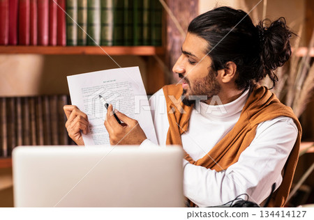 E-Teaching. Arab Teacher Guy At Laptop Computer Having Online Class Webinar With Student Via Video Call Sitting At Home. Online Tutoring, Distance Education Concept. Selective Focus 134414127