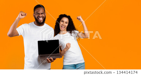 Multiracial Couple Showing Laptop Blank Screen Gesturing Yes Standing Over Yellow Studio Background. Man And Woman Recommending Website Showing Computer Monitor. Mockup, Panorama With Copy Space Multiracial Couple Showing Laptop Blank Screen Gesturing Yes Standing Over Yellow Studio Background. Man And Woman Recommending Website Showing Computer Monitor. Mockup, Panorama With Copy Space 134414174