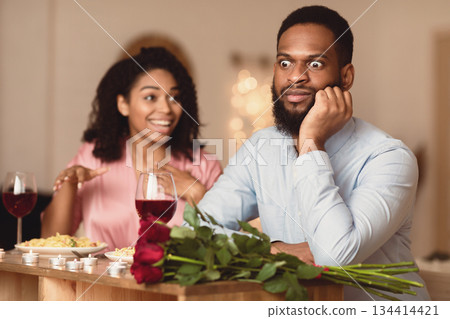 Bad Date. African American Couple Having Unsuccessful Blind Date In Restaurant, Funny Disappointed Shoked Black Man Feeling Embarrassment Listening To Excited Woman Talking 134414421