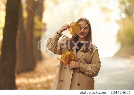 Happy woman is in the autumn forest Happy woman is in the autumn forest 134414665