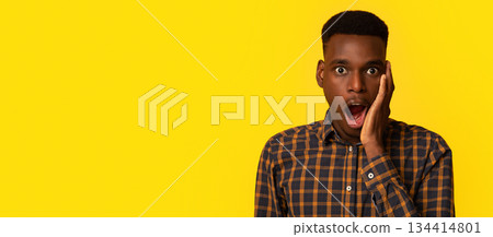 Unbelievable. Portraif Of Shocked Young Black Man Touching Face With Excitement, Amazed African American Guy Standing With Opened Mouth And Looking At Camera, Isolated On Yellow Background, Copy Space Unbelievable. Portraif Of Shocked Young Black Man Touching Face With Excitement, Amazed African American Guy Standing With Opened Mouth And Looking At Camera, Isolated On Yellow Background, Copy Space 134414801