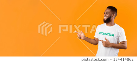 African American Male Volunteer Pointing Fingers Aside At Empty Space For Text Posing Standing Over Yellow Background, Studio Shot. Activist Guy Advertising Volunteering Project. Panorama 134414862