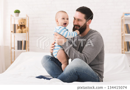 Little baby playing with daddy beard and laughing, copy space Little baby playing with daddy beard and laughing, copy space 134415074